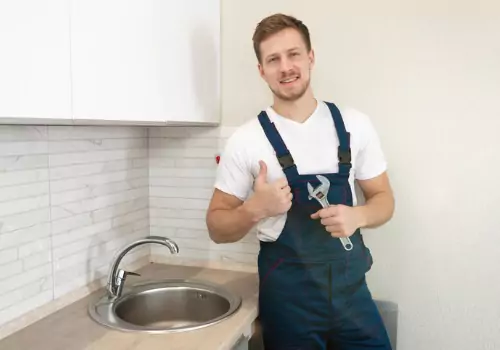 A plumber is seen at work. Reading Plumbing is a plumber near me. 
