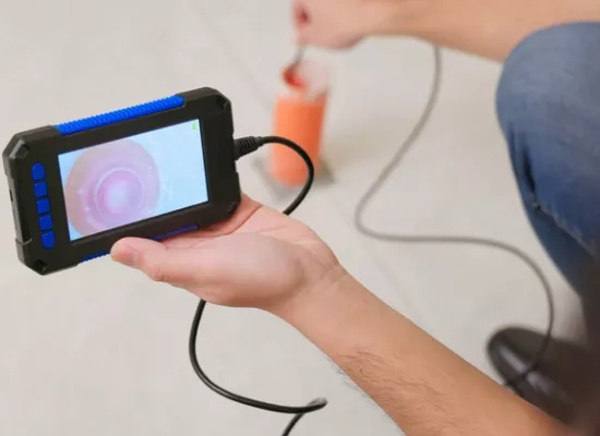 A plumber from Reading Plumbing uses a camera to inspect pipes as part of their sewer services
