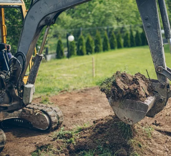 An excavator performing excavation work, part of the plumbing services offered by Reading & Son Plumbing
