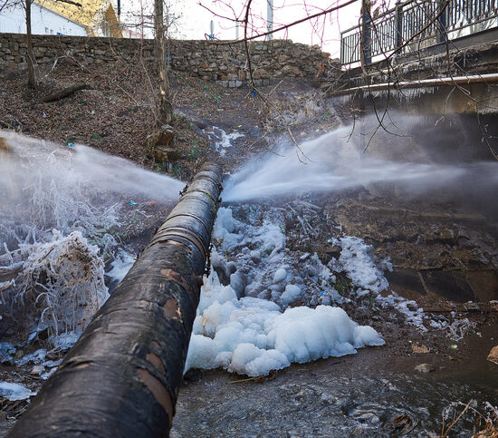 Sewer Cleaning East Peoria IL, Water pressure from a large pipe over the river, in winter