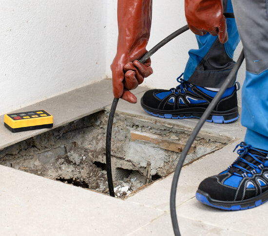 Best Residential Plumber Peoria IL, A skilled technician utilizes specialized equipment for essential plumbing maintenance and repairs efficiently