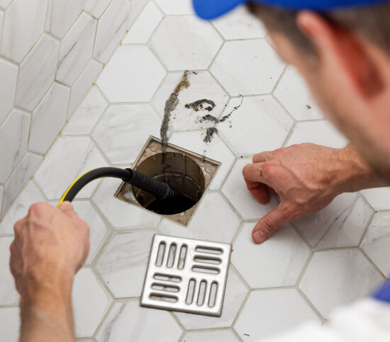 Best Residential Plumber Peoria IL, plumber unclogging blocked shower drain with hydro jetting at home bathroom. sewer cleaning service