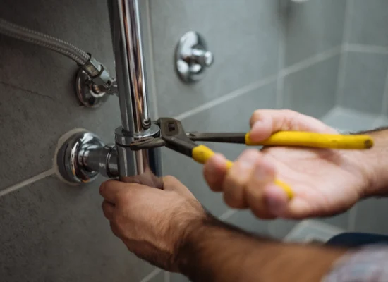 A plumber repairs bathroom pipes in a bathroom in Morton IL